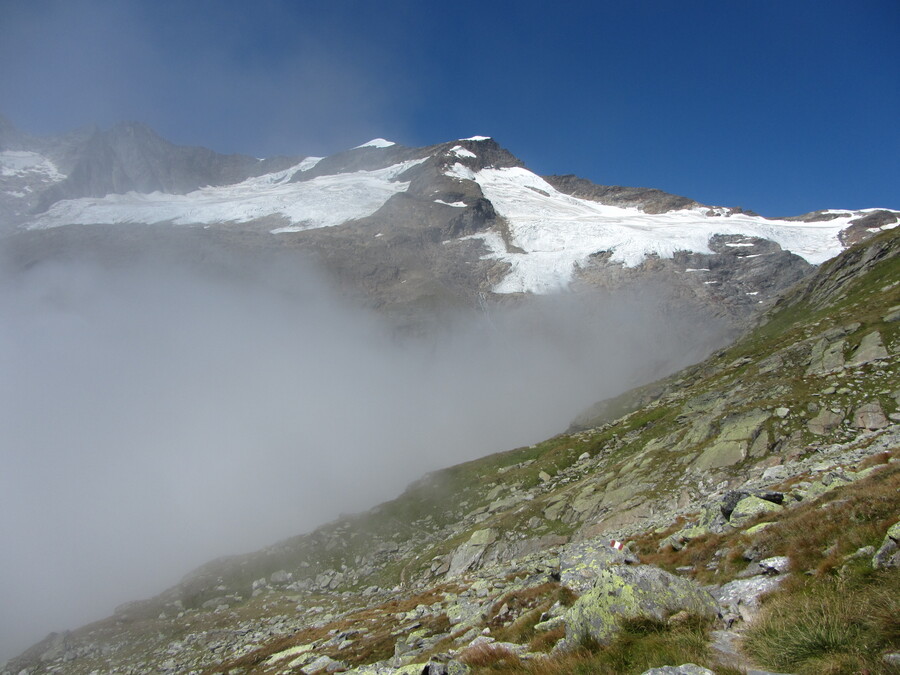 De Simonyspitzen liggen in de volle zon boven de wolken